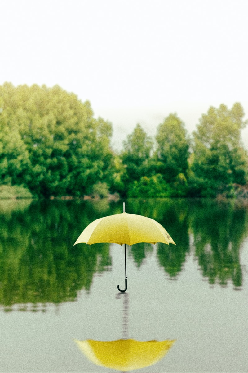 Solutions Umbrella 55 yellow umbrella on surface of water at daytime